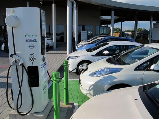 Une Nissan LEAF 100 % électrique se rechargeant sur une borne rapide installée sur une station d’autoroute italienne